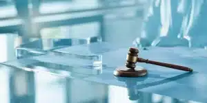 A malpractice lawyer reviews case documents at an office desk.